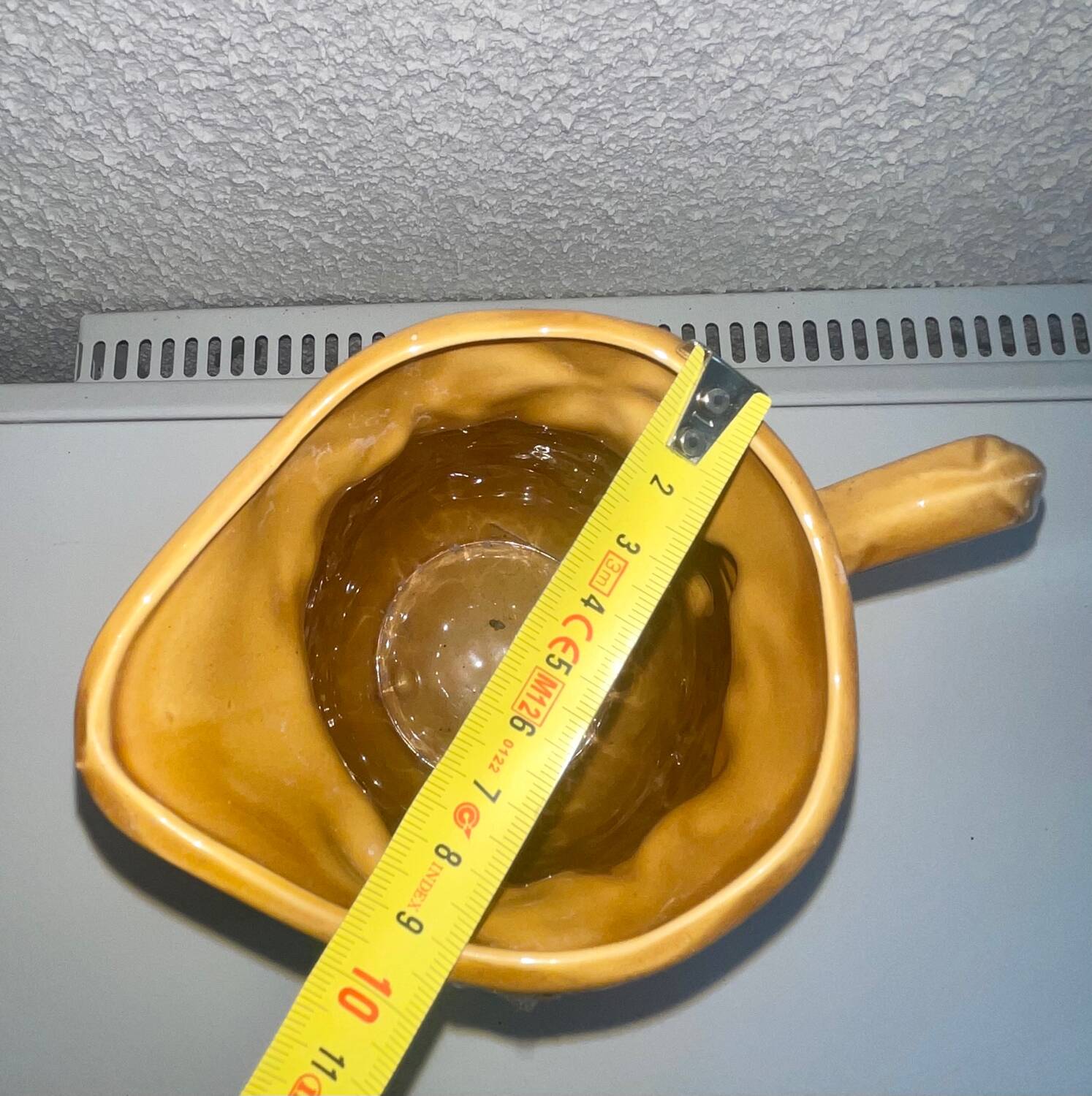 Antique pitcher with flower decoration