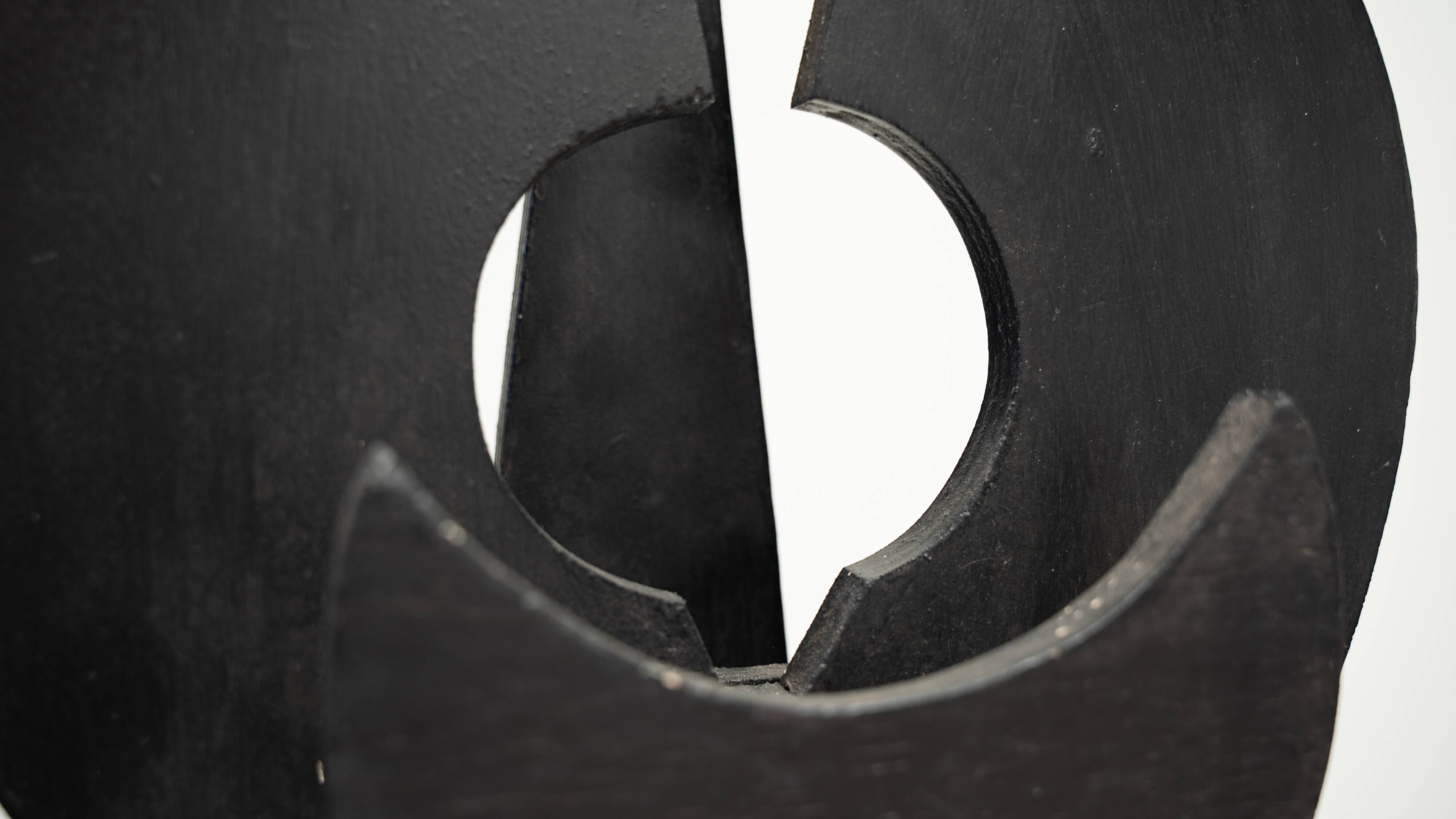 Black brutalist wooden sculpture