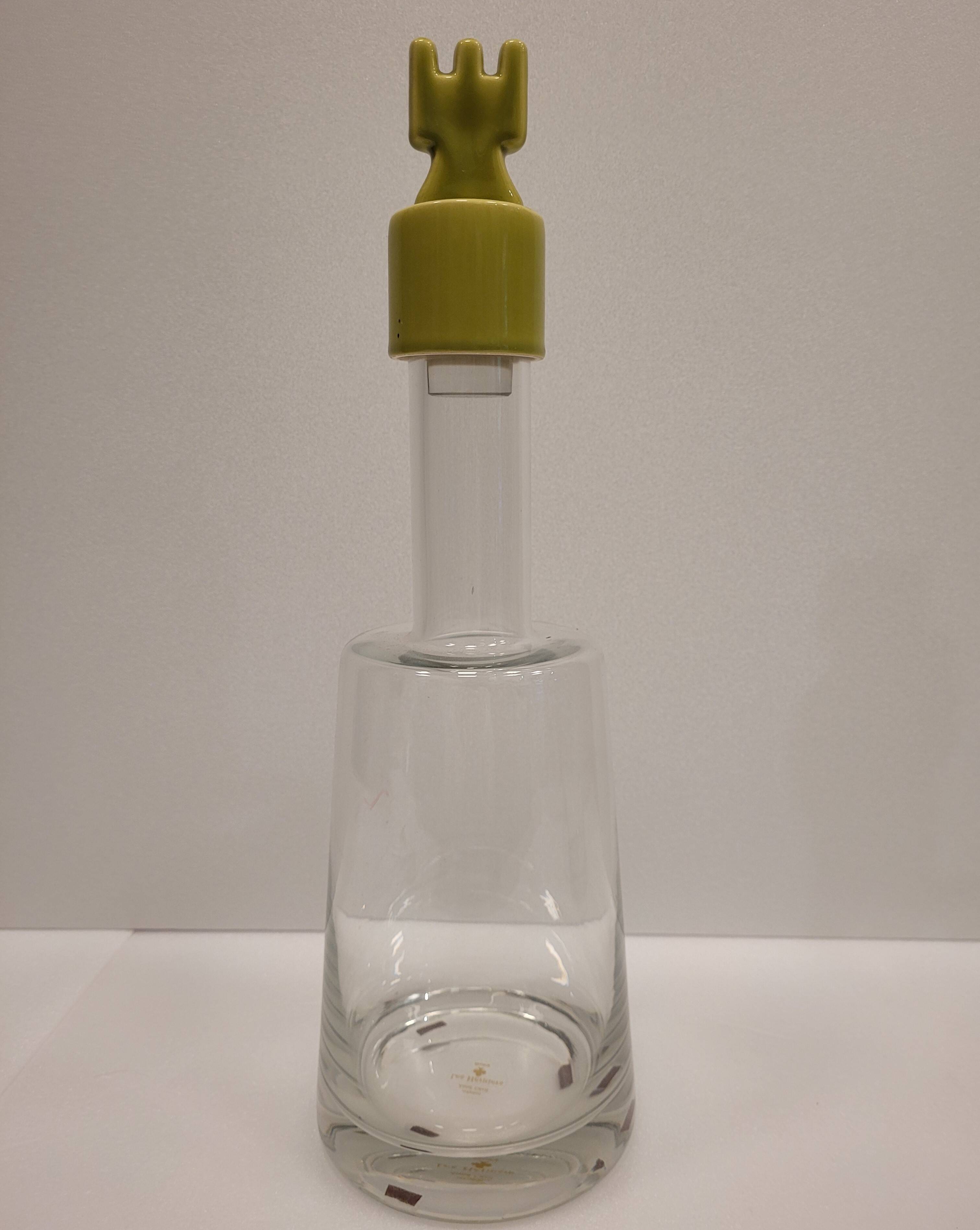 pair of decanters, bottles or jars, made in crystal with a ceramic tap enameled in green color