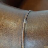 Sheep leather club chair in a cognac color and finished with piping