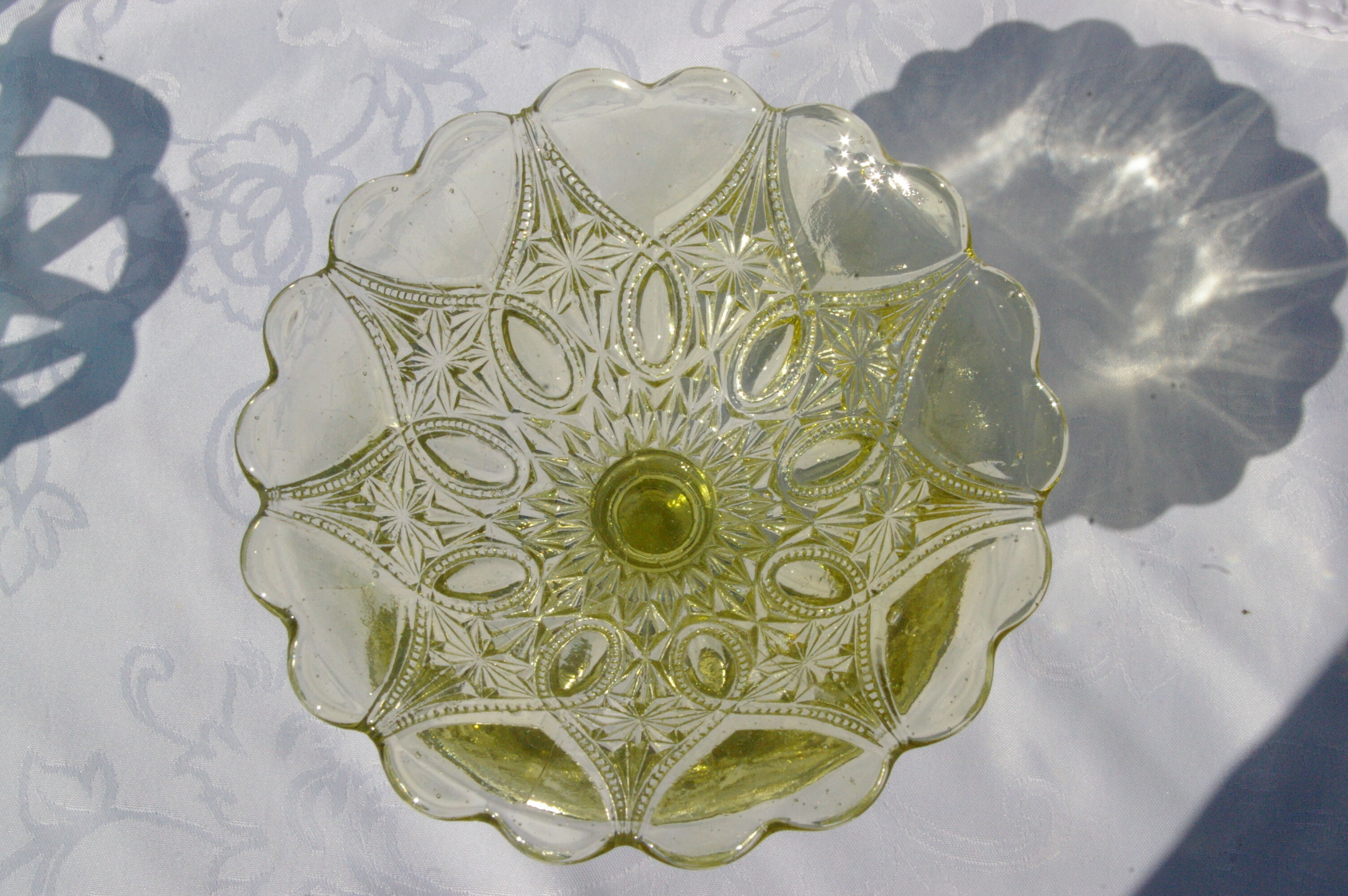 Old small cut on foot in yellow molded glass