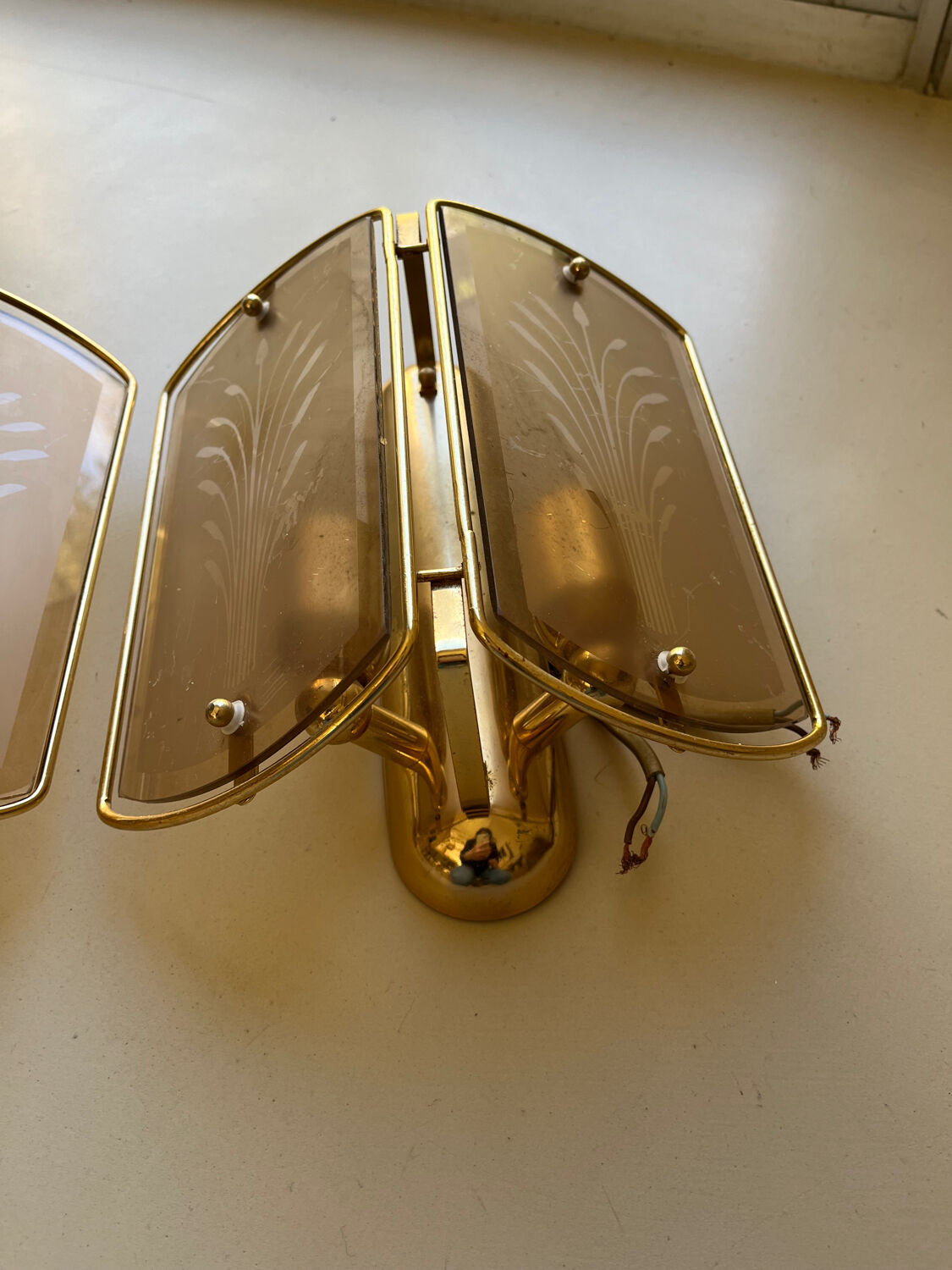 Pair of brass and smoked glass wall lights