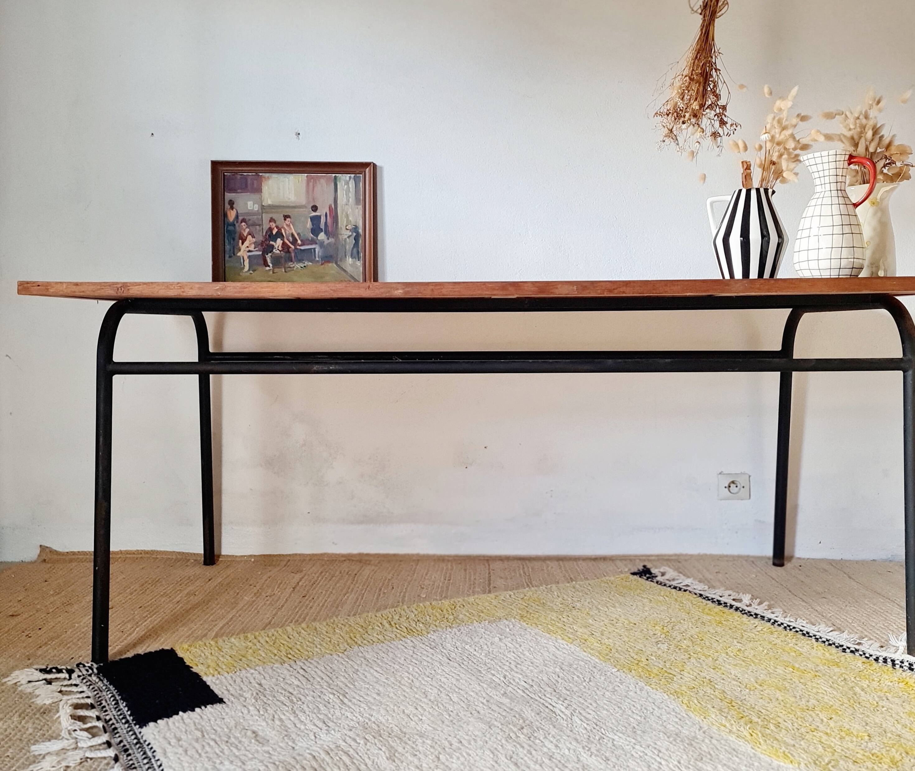 Metal tubular base table with a wooden top.