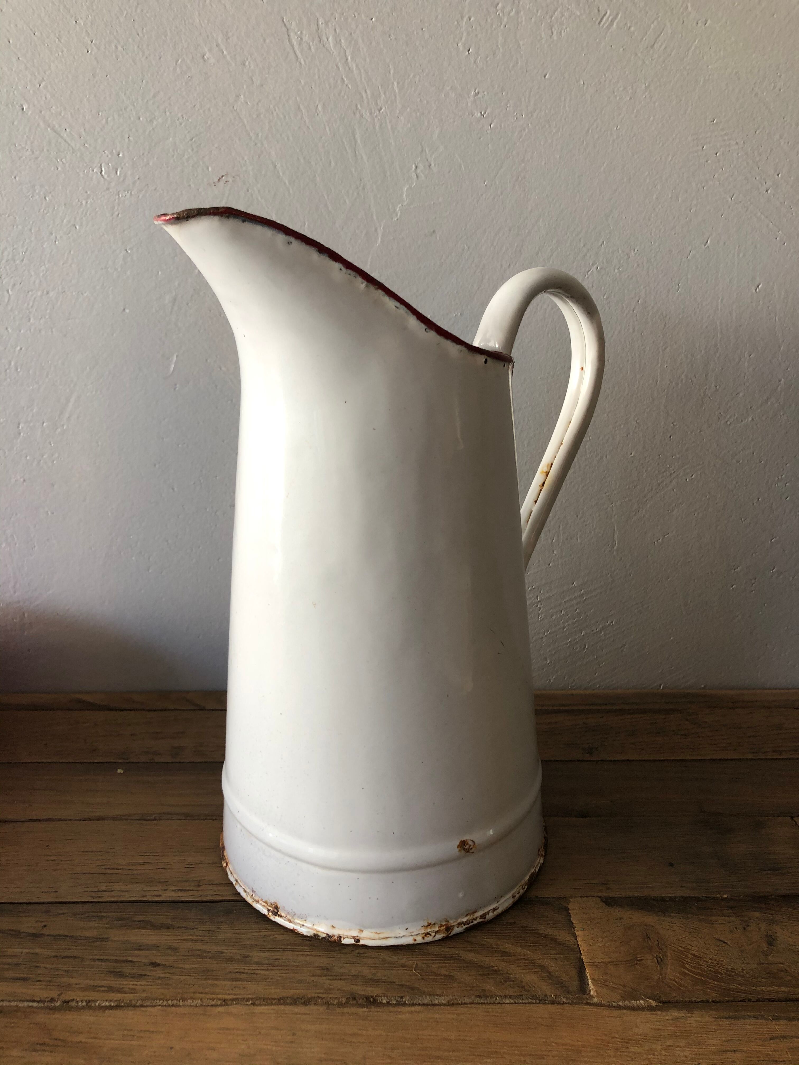 Old pitcher in enamelled sheet metal