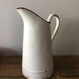 Old pitcher in enamelled sheet metal