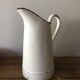 Old pitcher in enamelled sheet metal