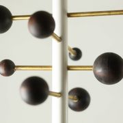 Coat rack from floor to ceiling in lacquered metal and brass. Contemporary.