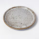 Handcrafted stoneware cup and its saucer – Speckled glaze
