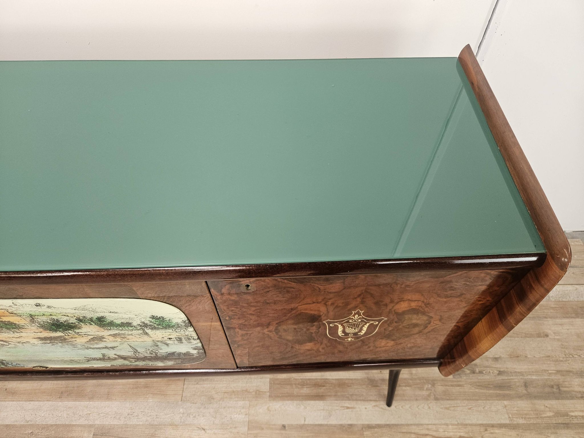 1950s mahogany sideboard with a glass top and central bar.
