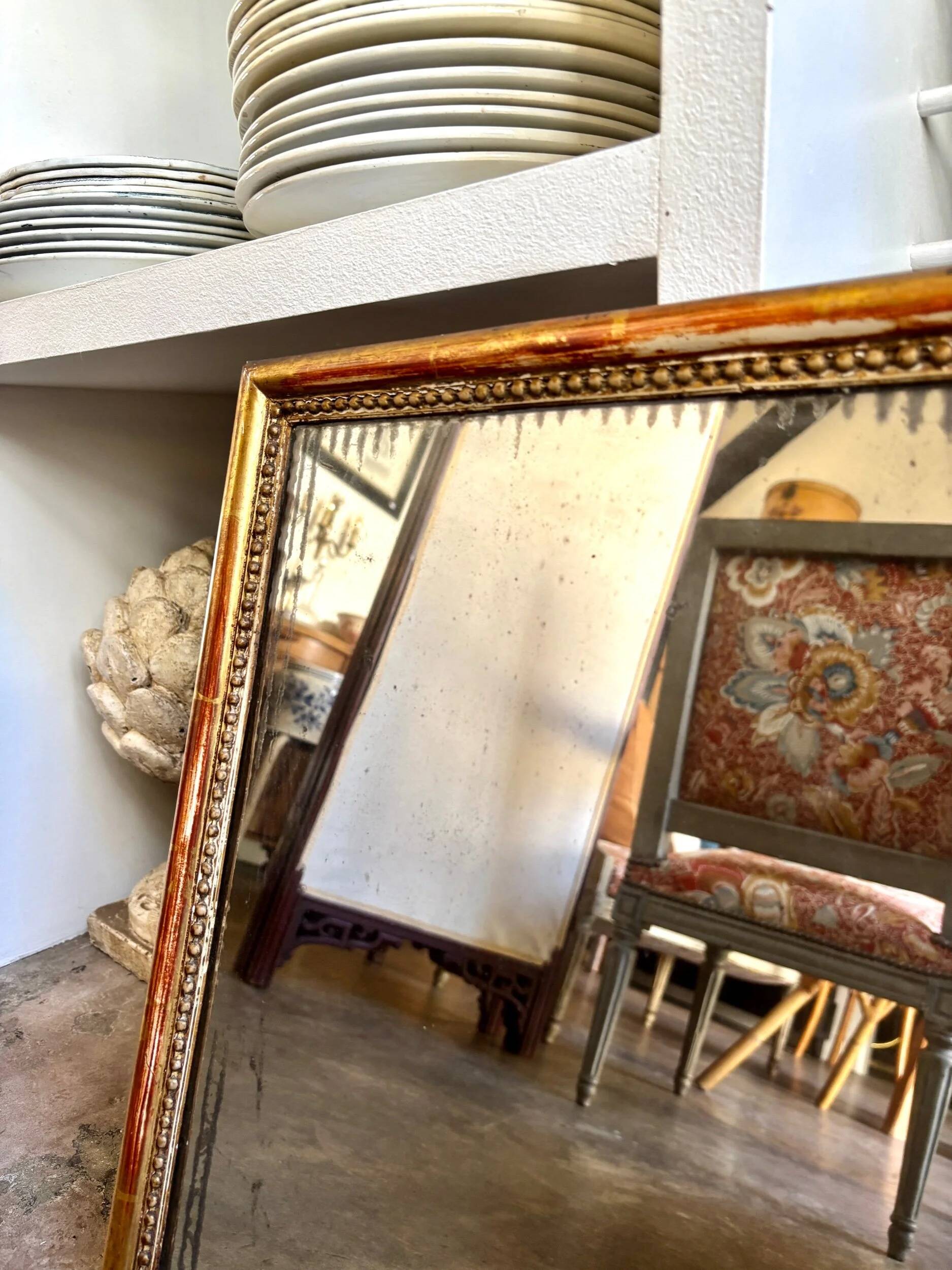 Wooden mirror with gilded stucco and beaded frieze, 45 x 37 cm