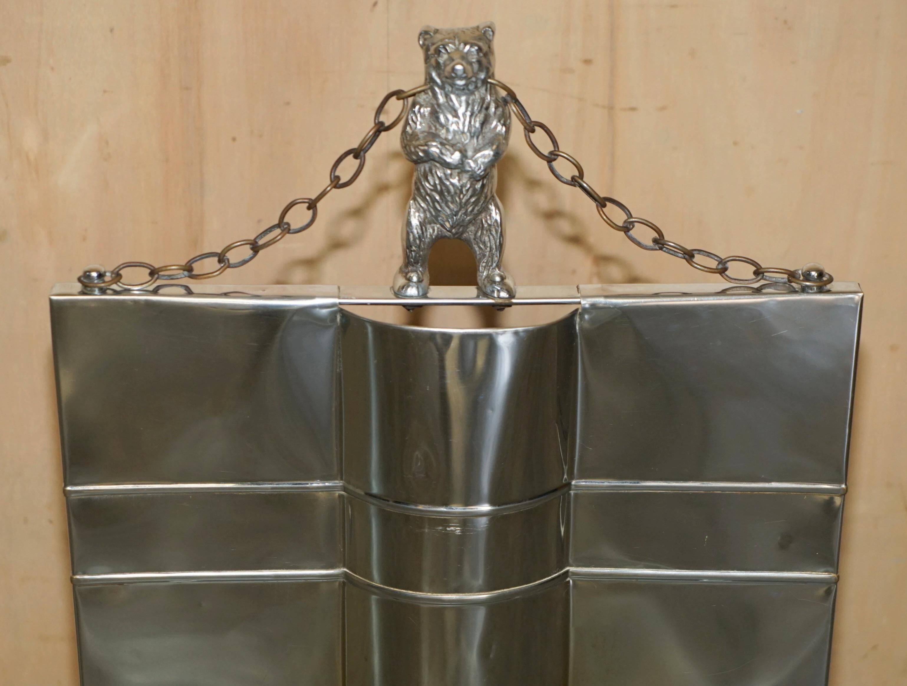Art Deco fire screen from around 1920 in polished chrome with a bear.