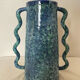 Blue-green ceramic vase with abstract wavy handles
