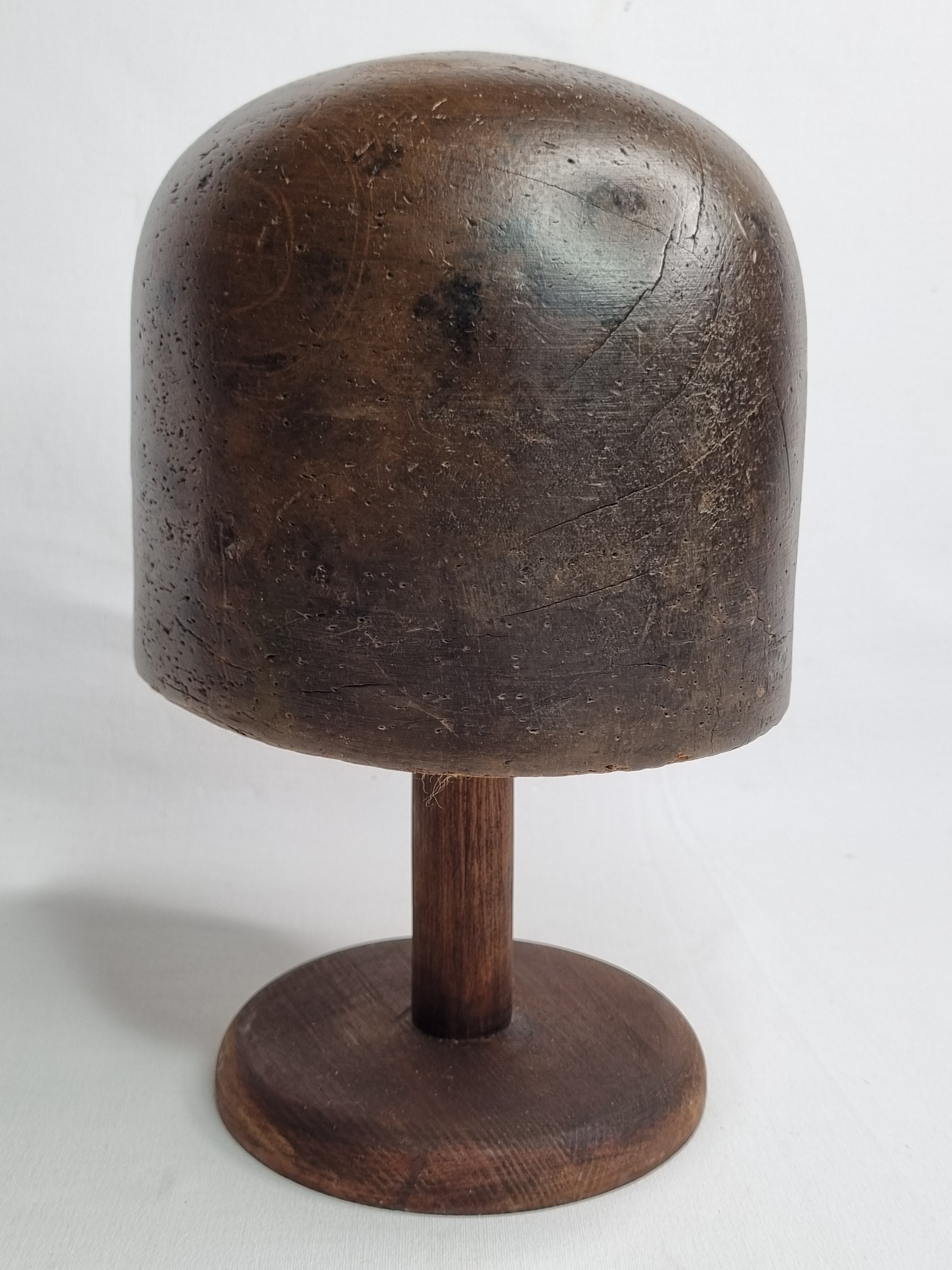 Old solid wood hat shape on foot, 1900