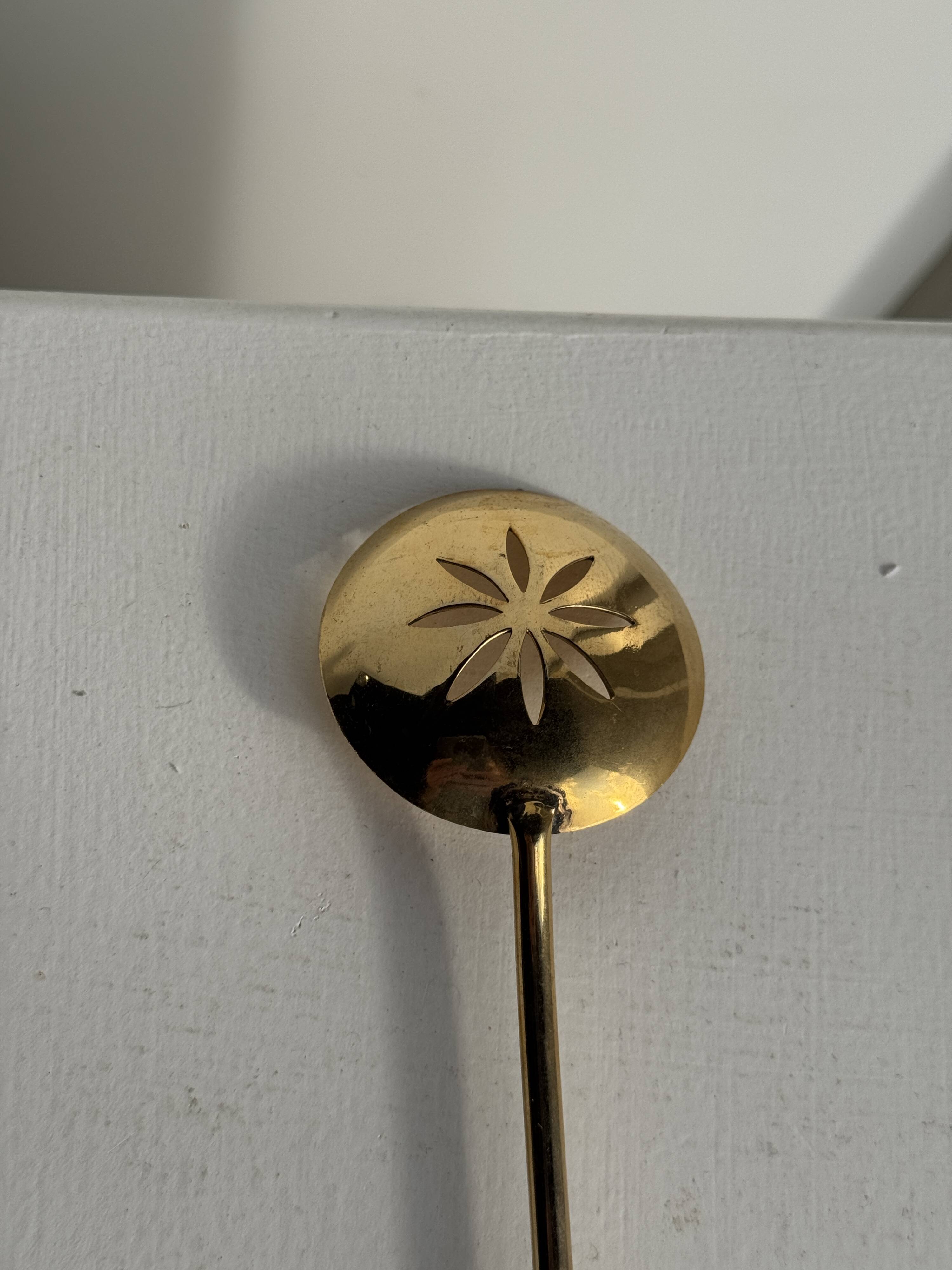 Small golden glass ice bucket with diamond point design and its scoop.