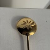 Small golden glass ice bucket with diamond point design and its scoop.