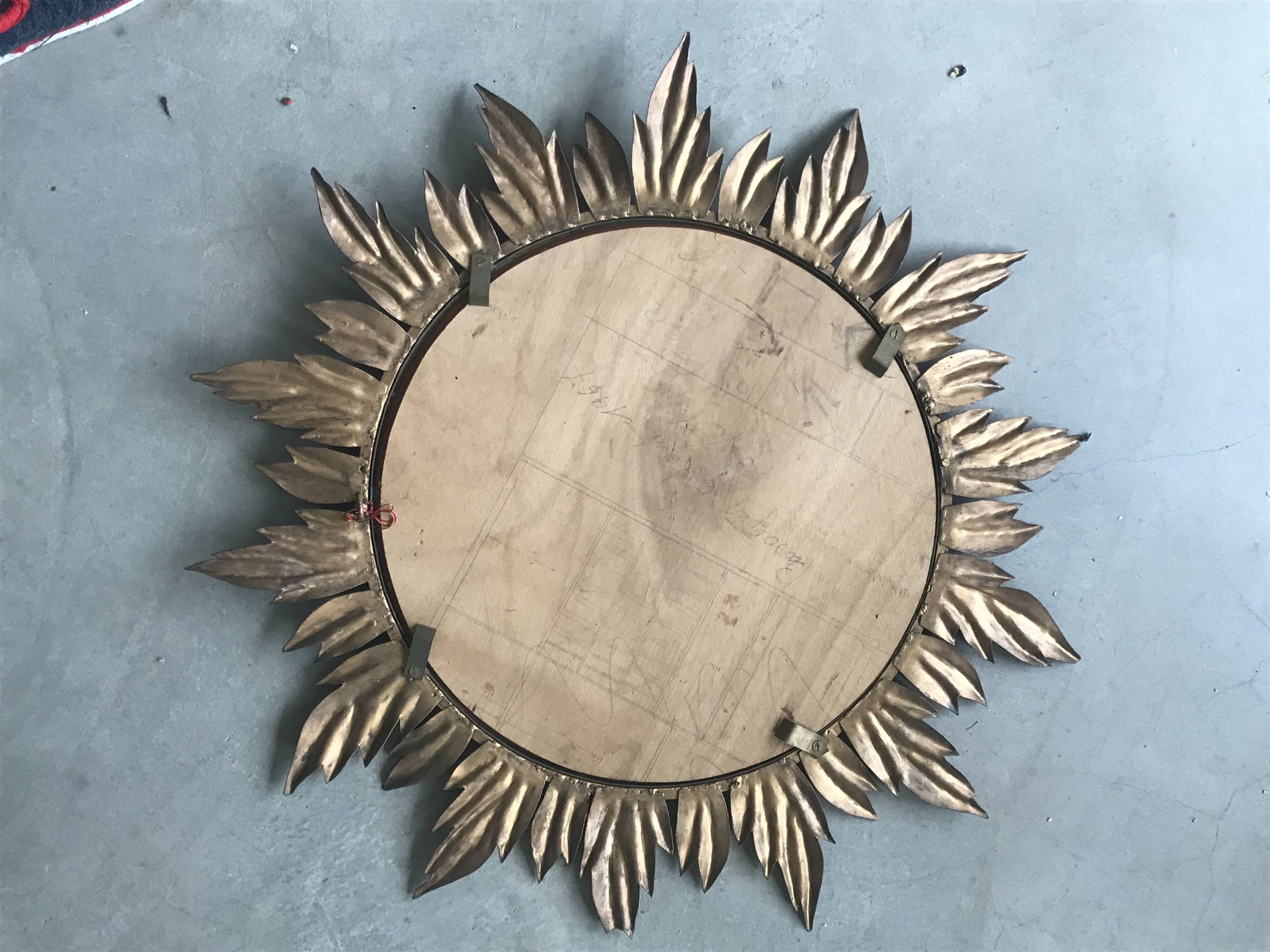 Sun mirror decorated with golden leaves, circa 1950.