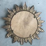 Sun mirror decorated with golden leaves, circa 1950.
