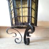 Large hanging lantern in wrought iron and opaque yellow-orange windows