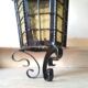 Large hanging lantern in wrought iron and opaque yellow-orange windows