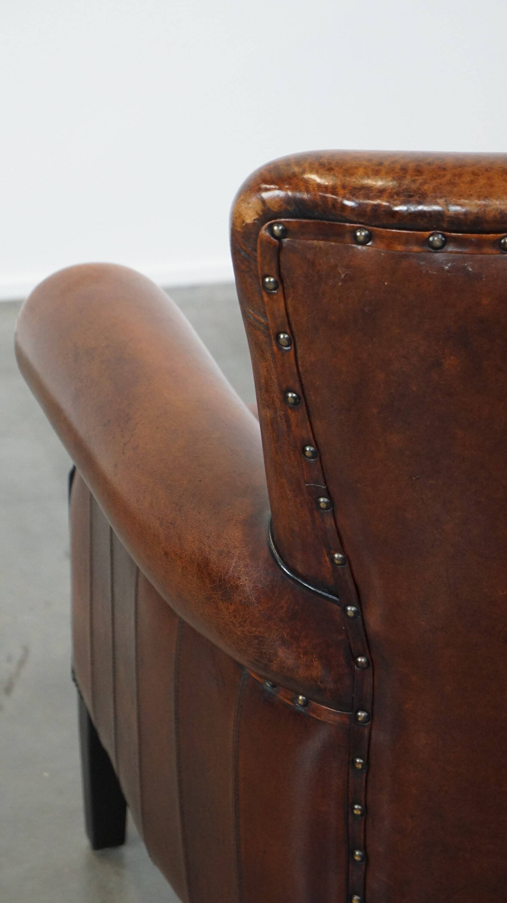 Sheepskin armchair/lounge chair finished with decorative nailheads