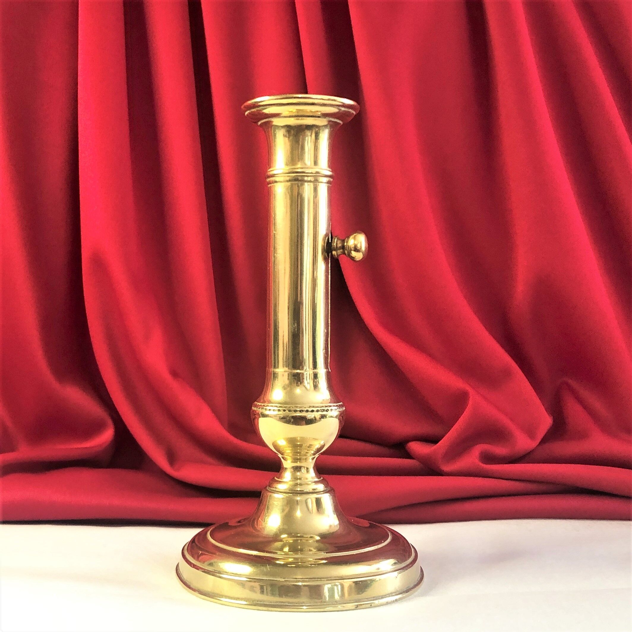Gilded copper push candle holder