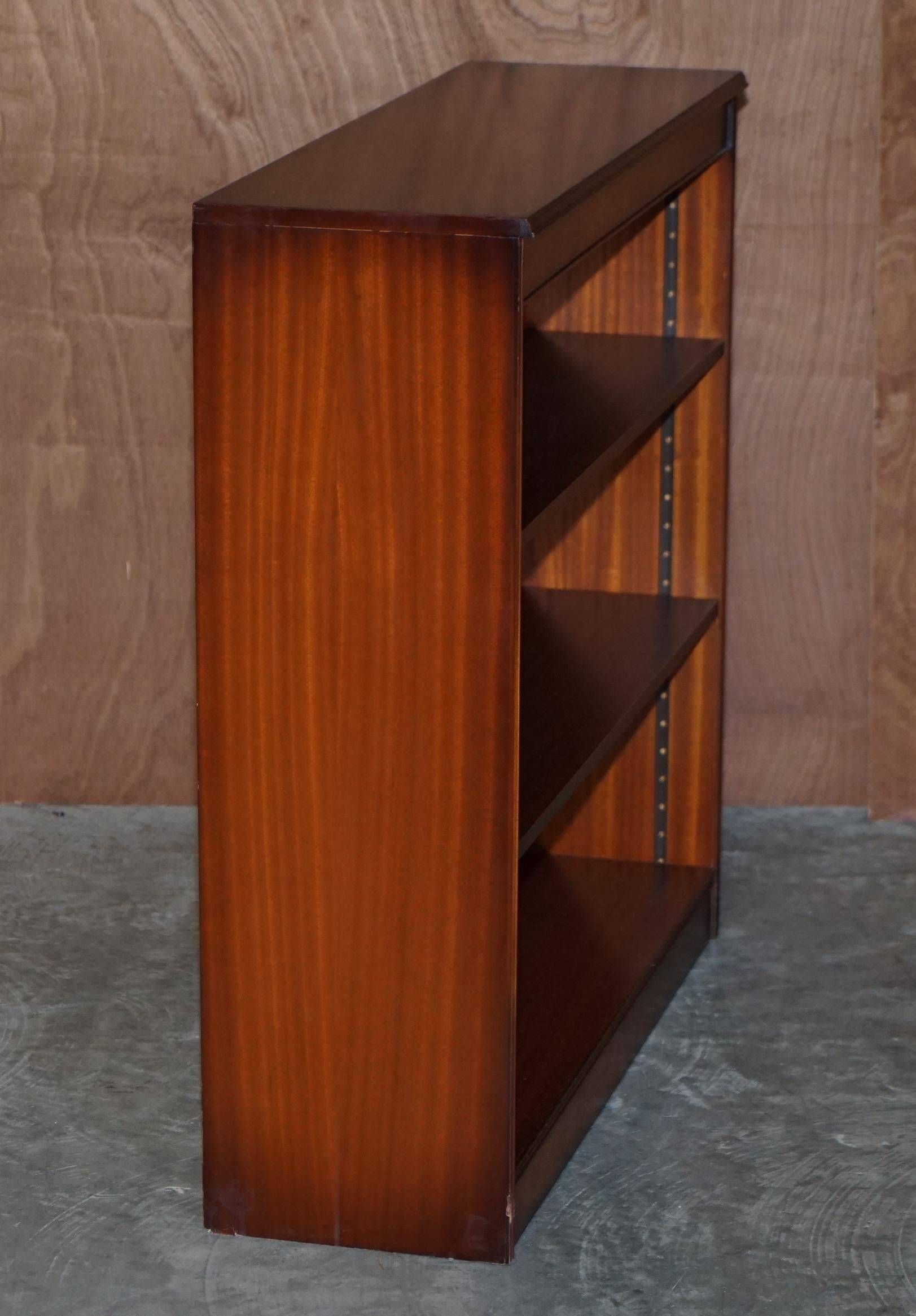 Pair of open dwarf bookshelves in mahogany by Shaws of London.