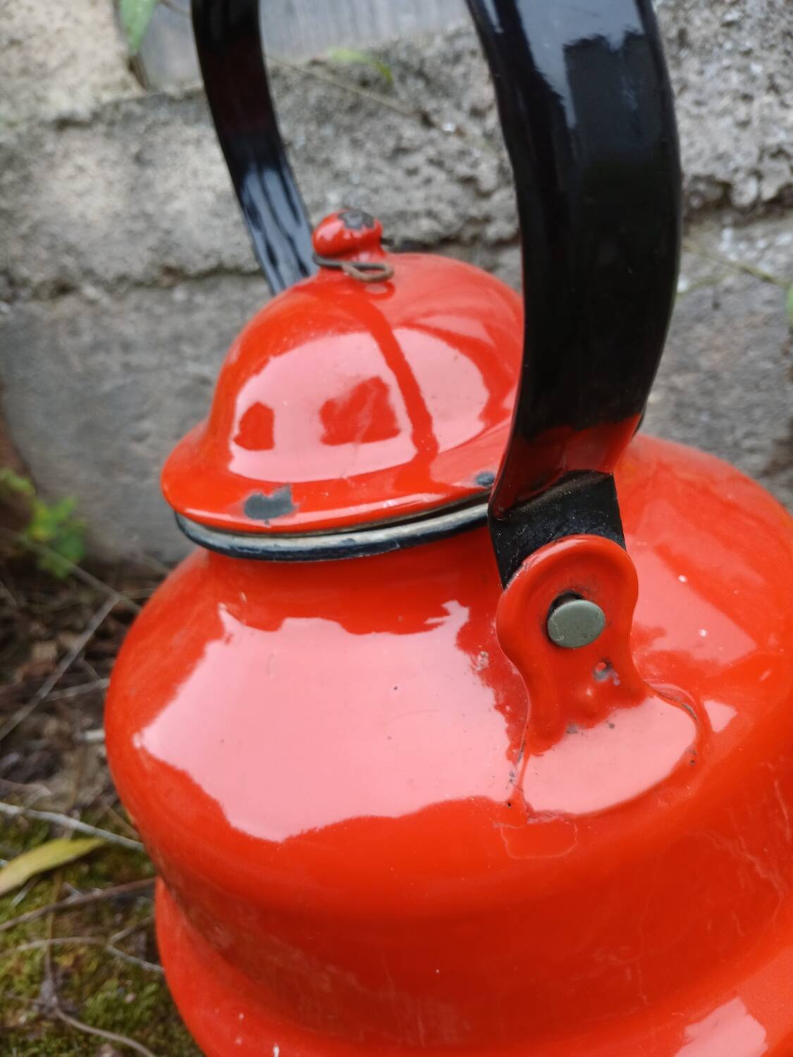 Antique teapot in red enamelled sheet metal