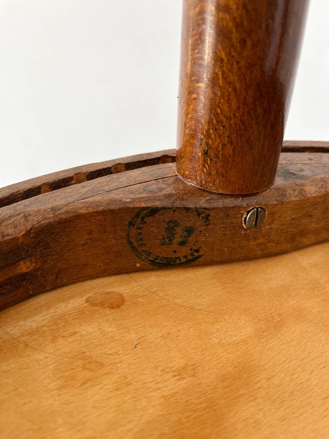 2 antique bistro stools with curved wood and caning effect.