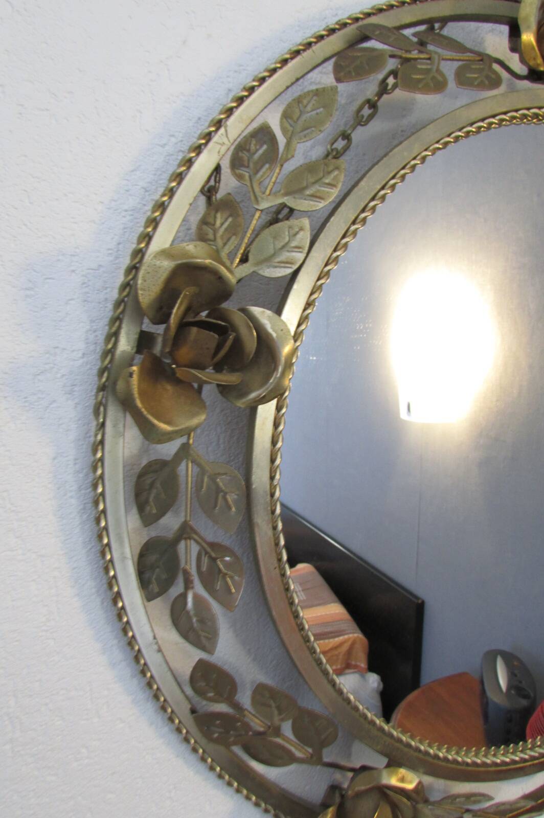 Round gold metal mirror, rose crown