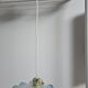 Suspension lampshade with scalloped edges in blue and its interior decoration.