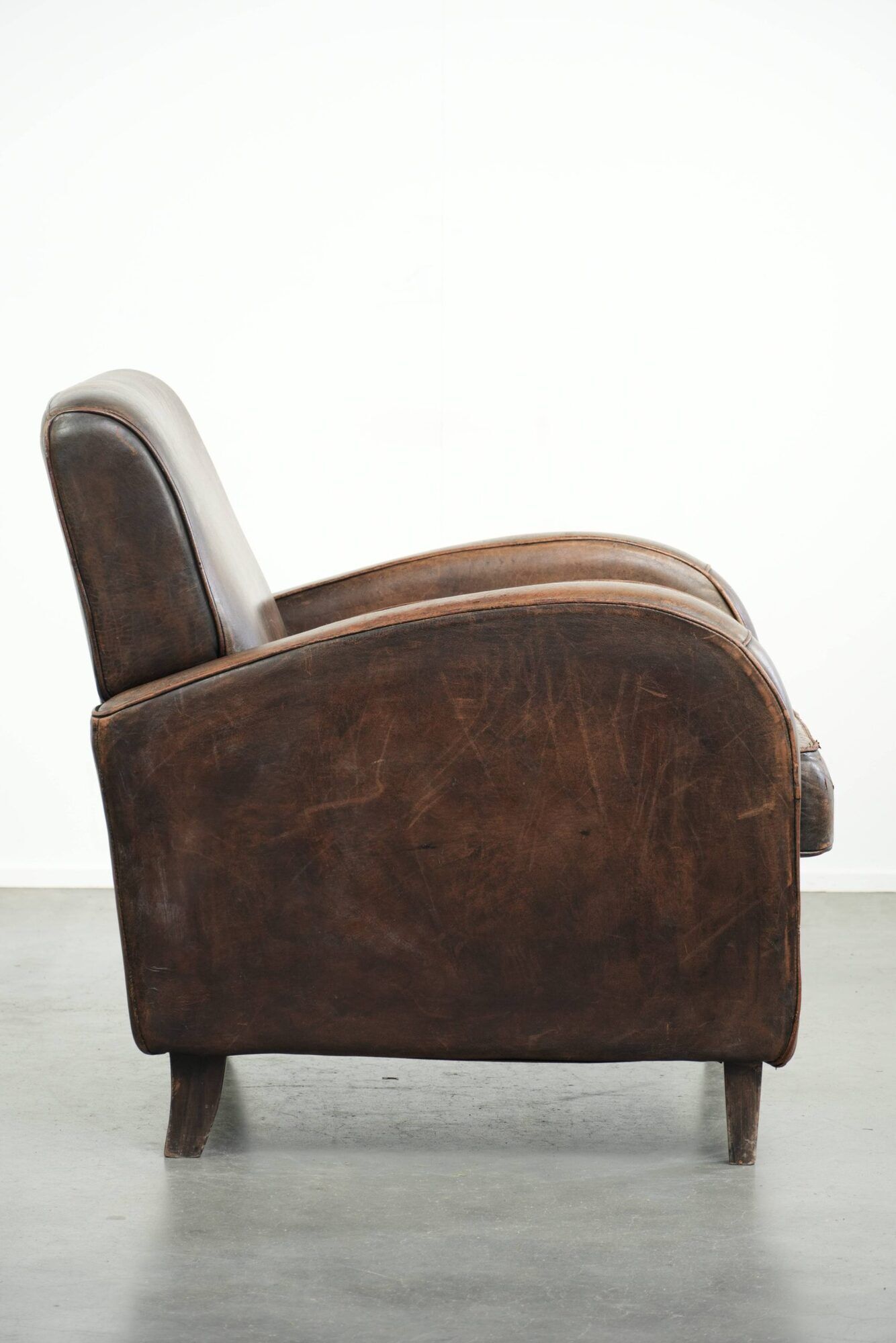 Comfortable sheepskin armchair with matching piping and a timeless look
