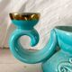 Pair of turquoise and gold double candlesticks