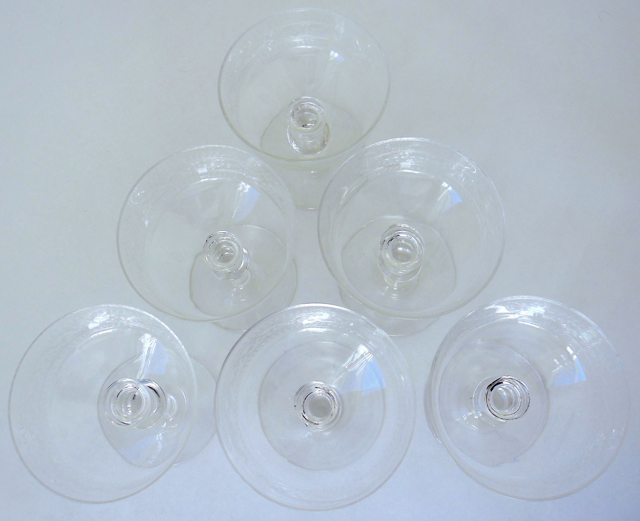 Suite of six champagne glasses on foot in engraved colorless crystal