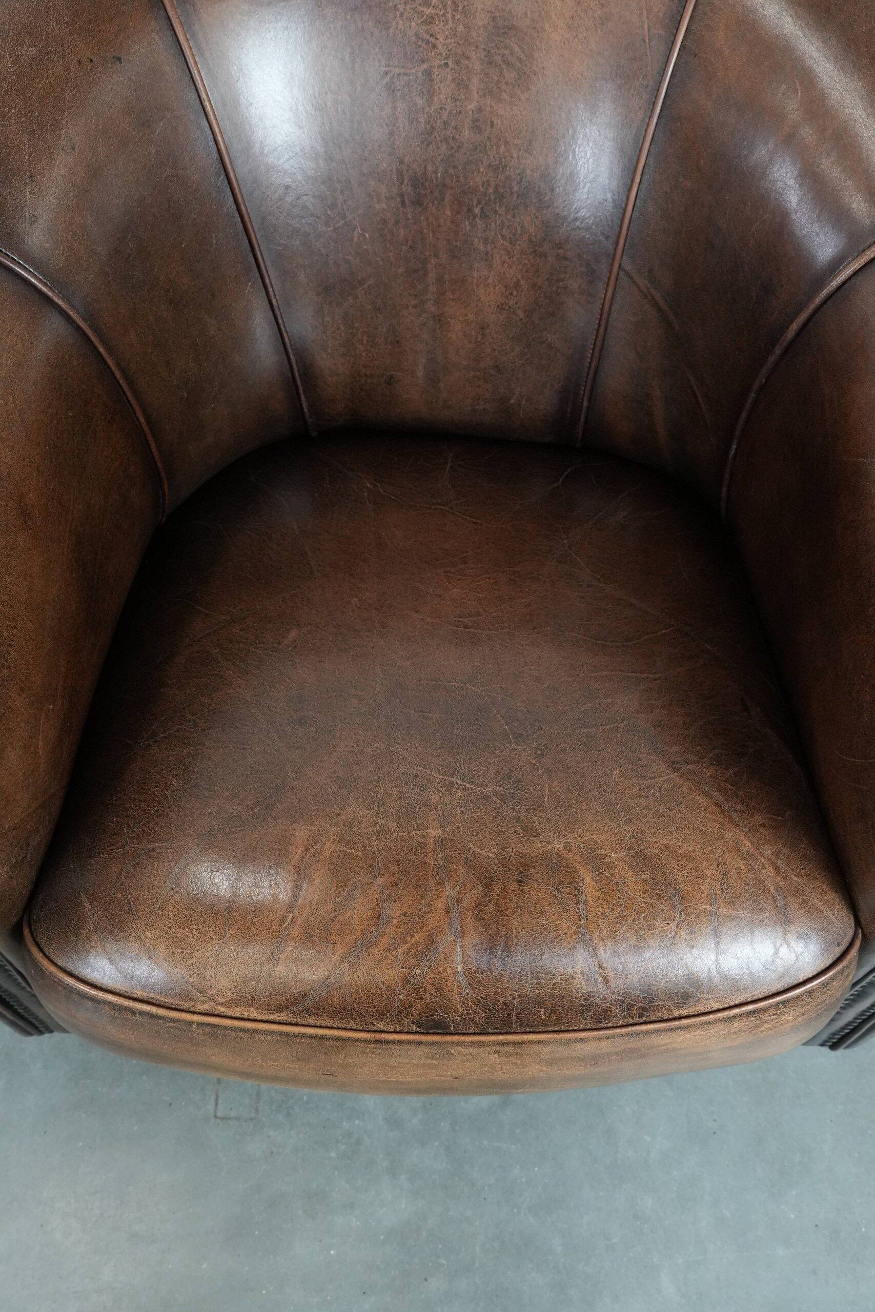 Set of two sheepskin club armchairs with fixed seat cushions