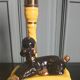 Zoomorphic lamp "poodle" in black, yellow, and gold glazed ceramic.