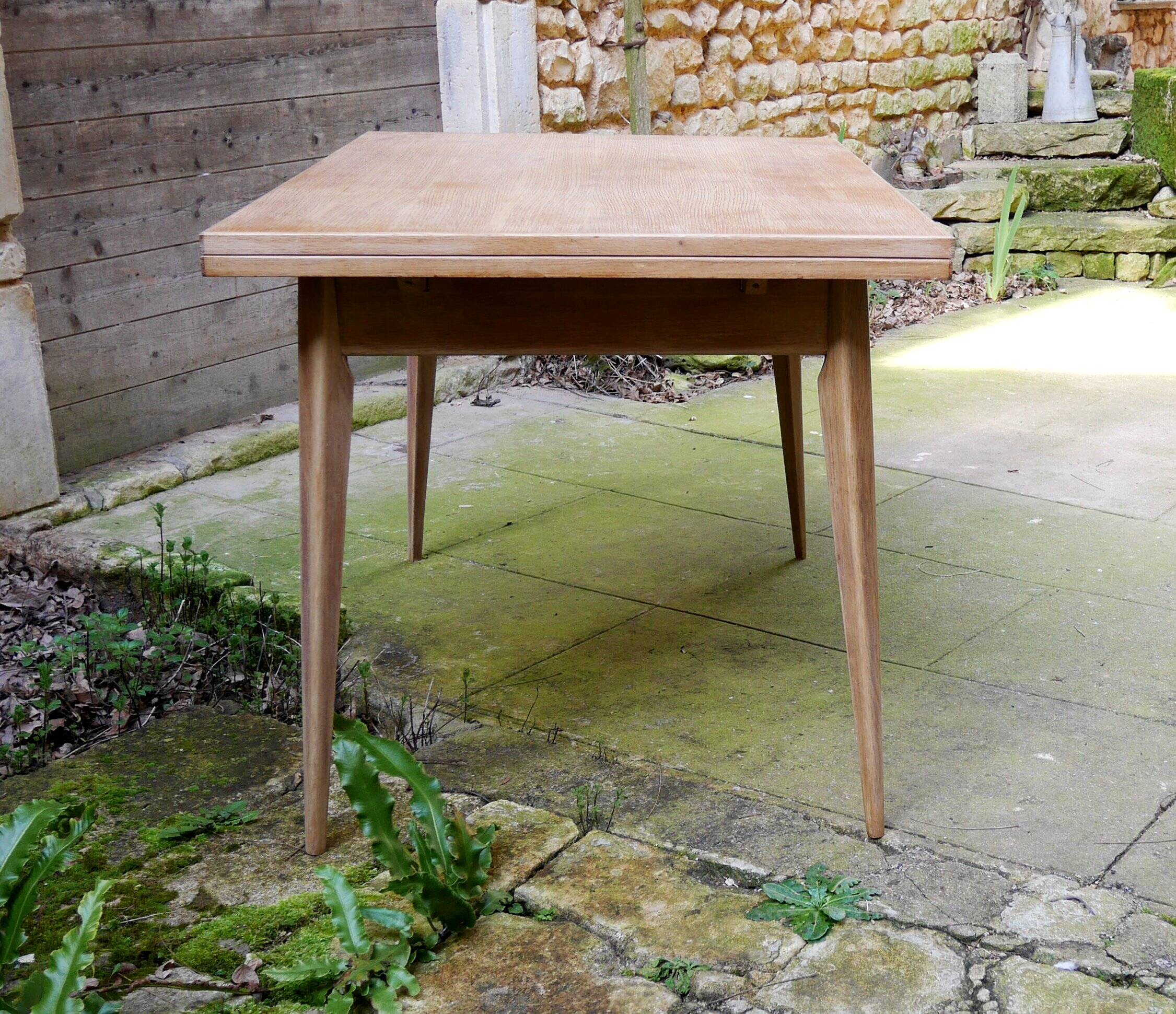 wooden dining table with compass legs and extensions