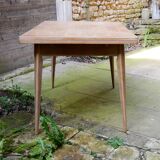 wooden dining table with compass legs and extensions