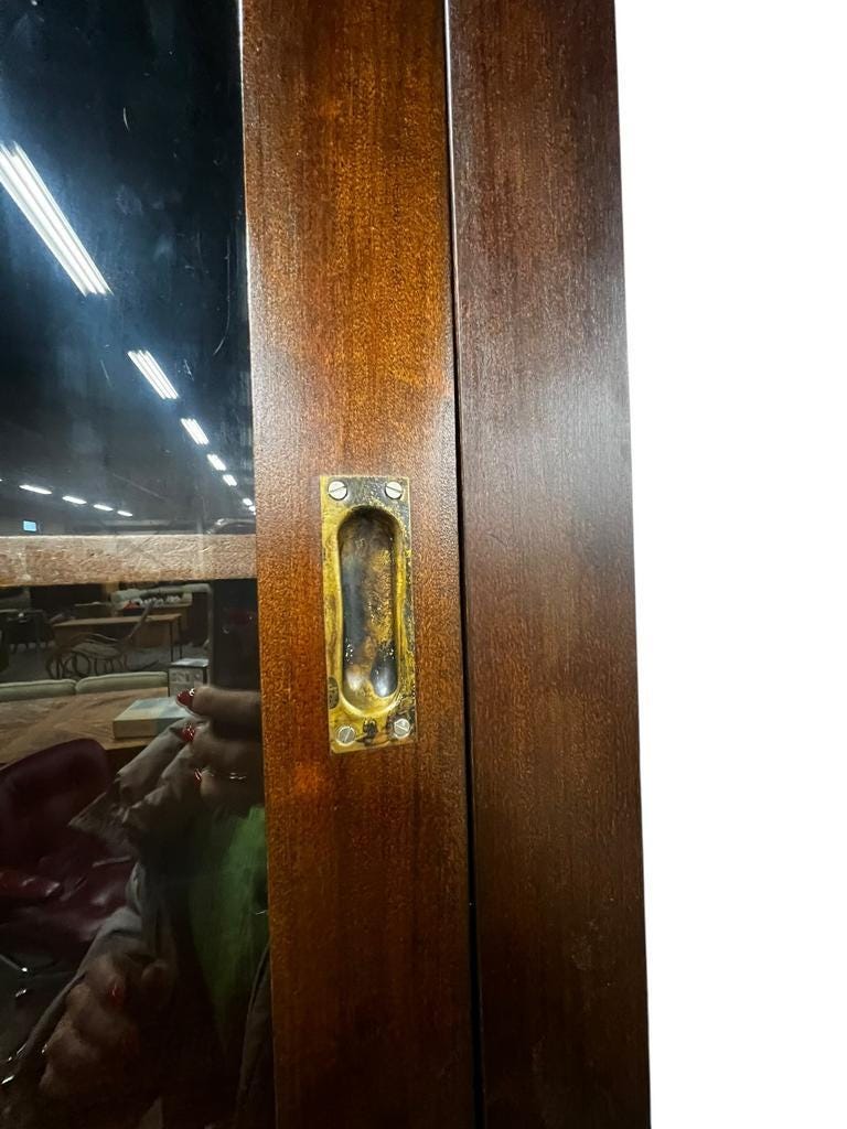 Vintage wooden display cabinet with sliding doors.