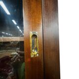 Vintage wooden display cabinet with sliding doors.