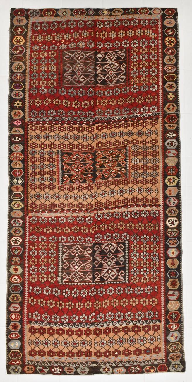 Kilim anatolien ancien tons rouges et beiges, motifs tribaux colorés