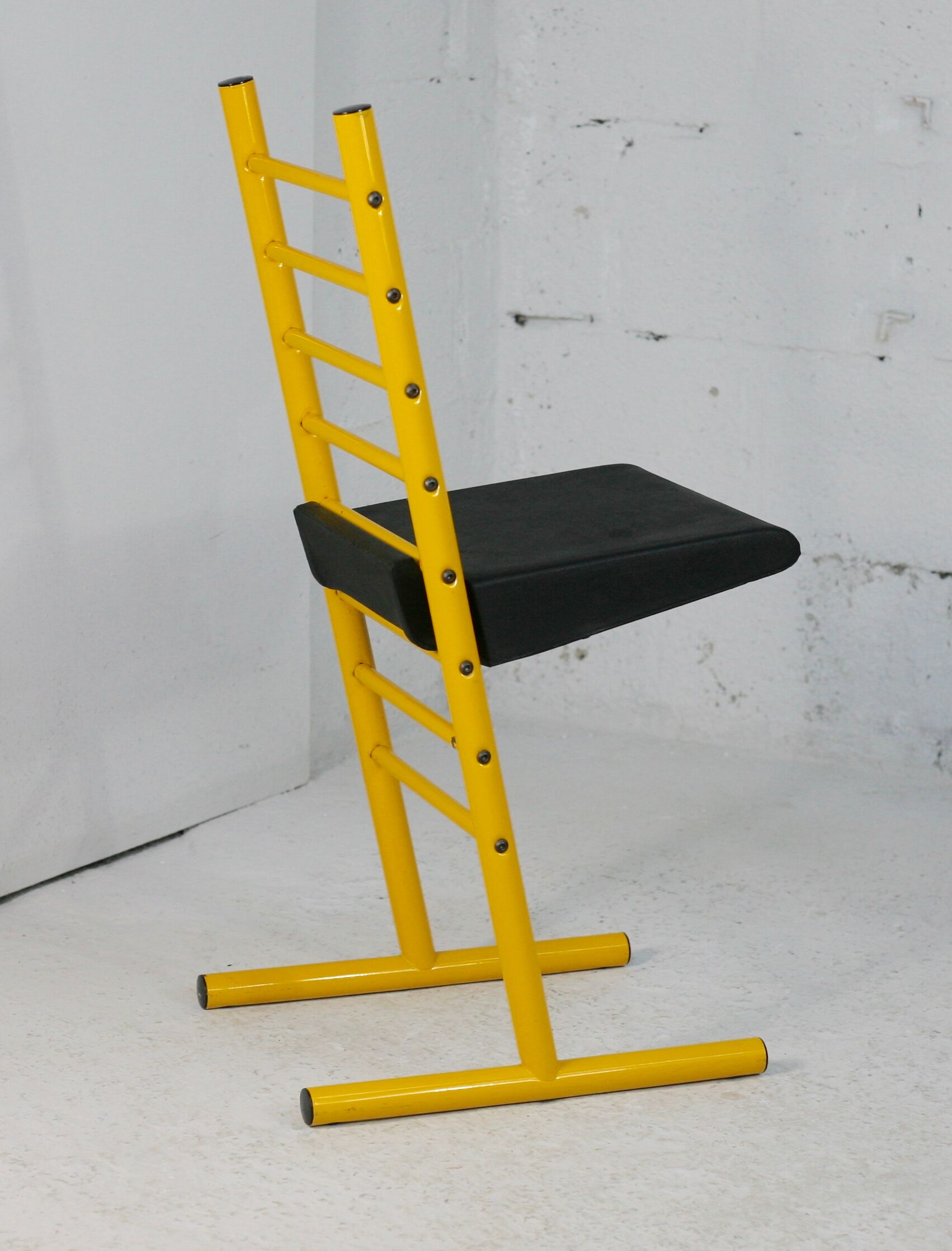 Adjustable seat chair. Circa 1980. Italy. Yellow lacquered steel.