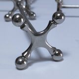 Eleven 70s design metal "crosshair" knife holders