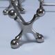 Eleven 70s design metal "crosshair" knife holders