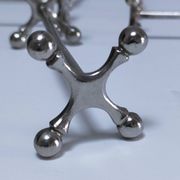 Eleven 70s design metal "crosshair" knife holders