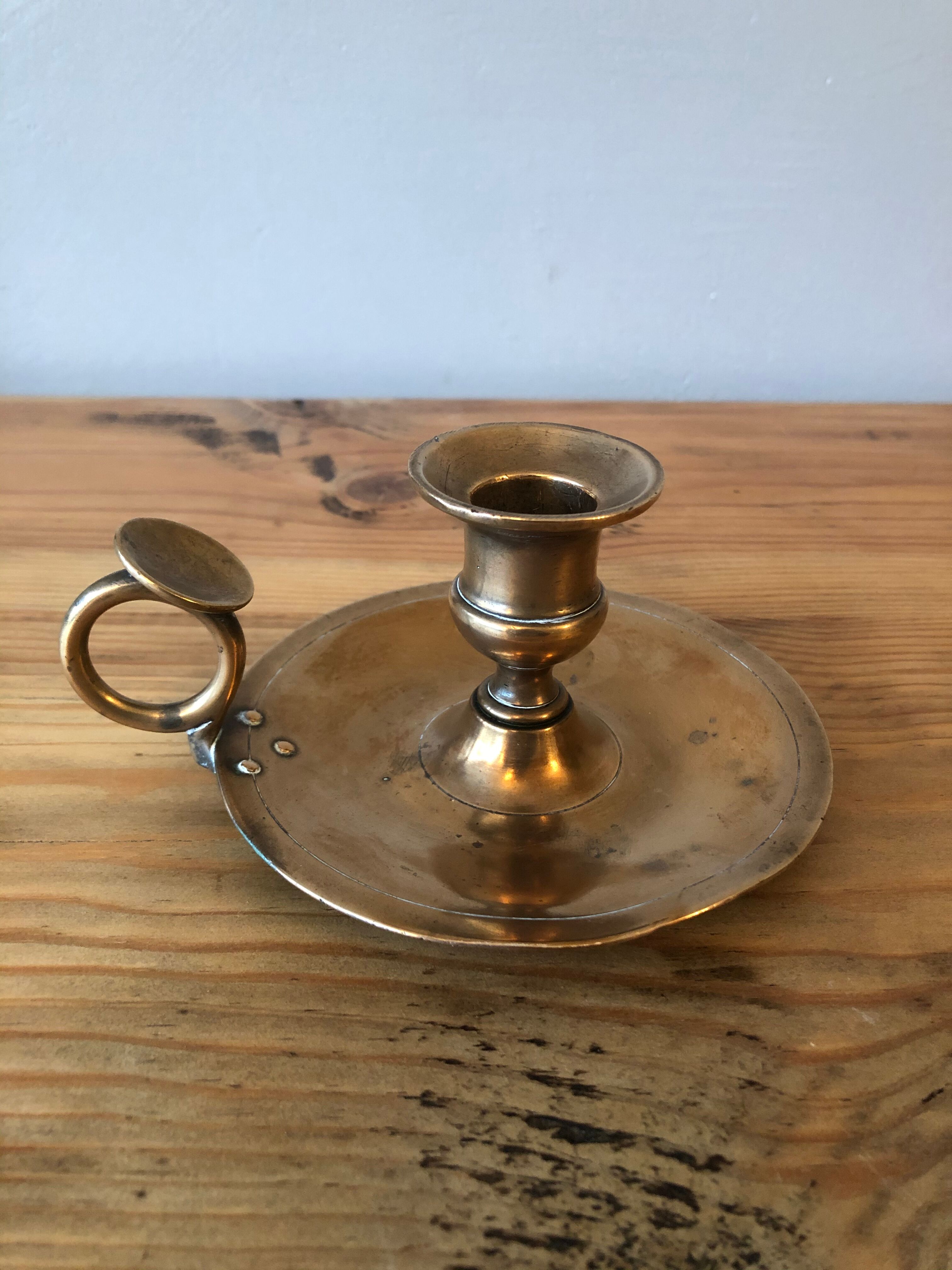 Old copper hand-held candlestick