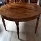 Antique half-moon walnut round table