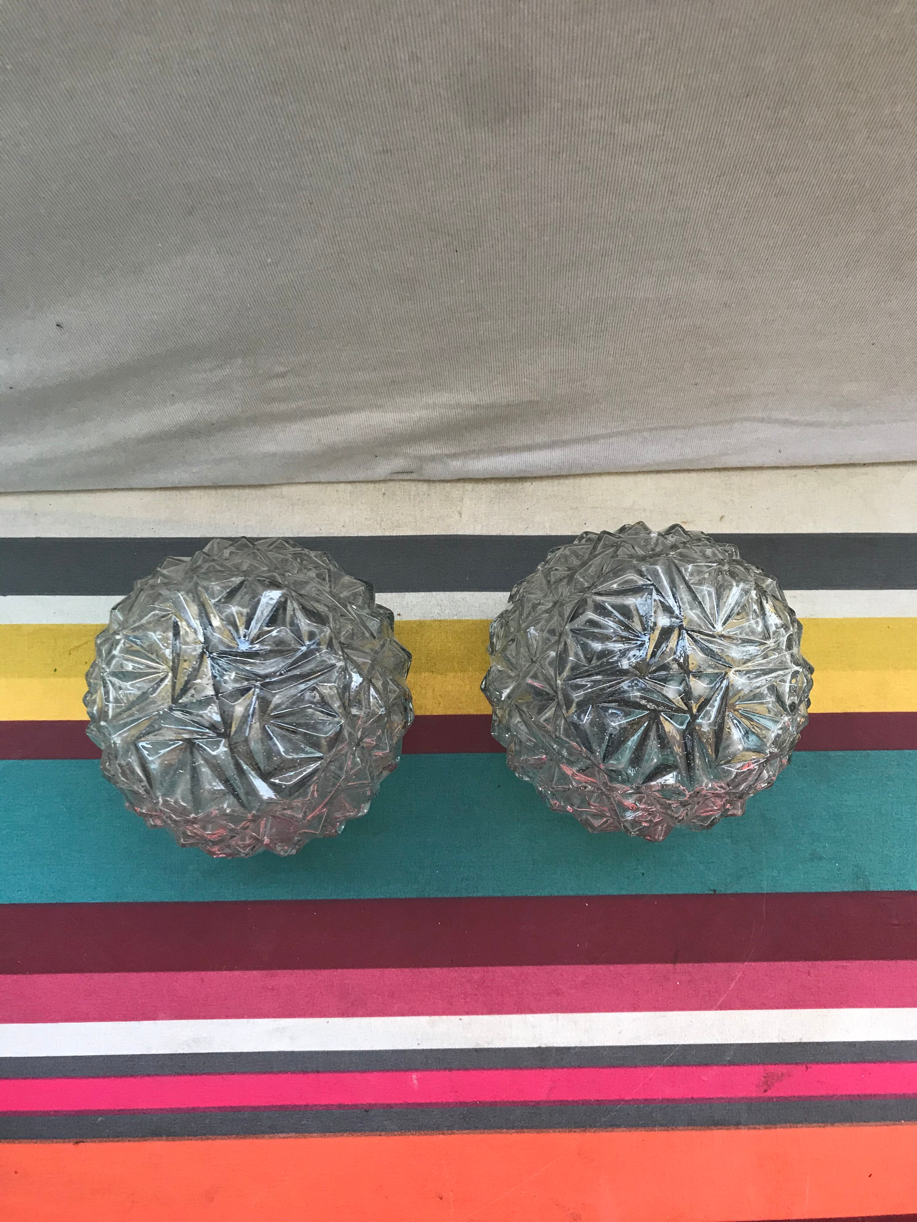 Old pair of glass moulded wall sconces with vintage black metal support