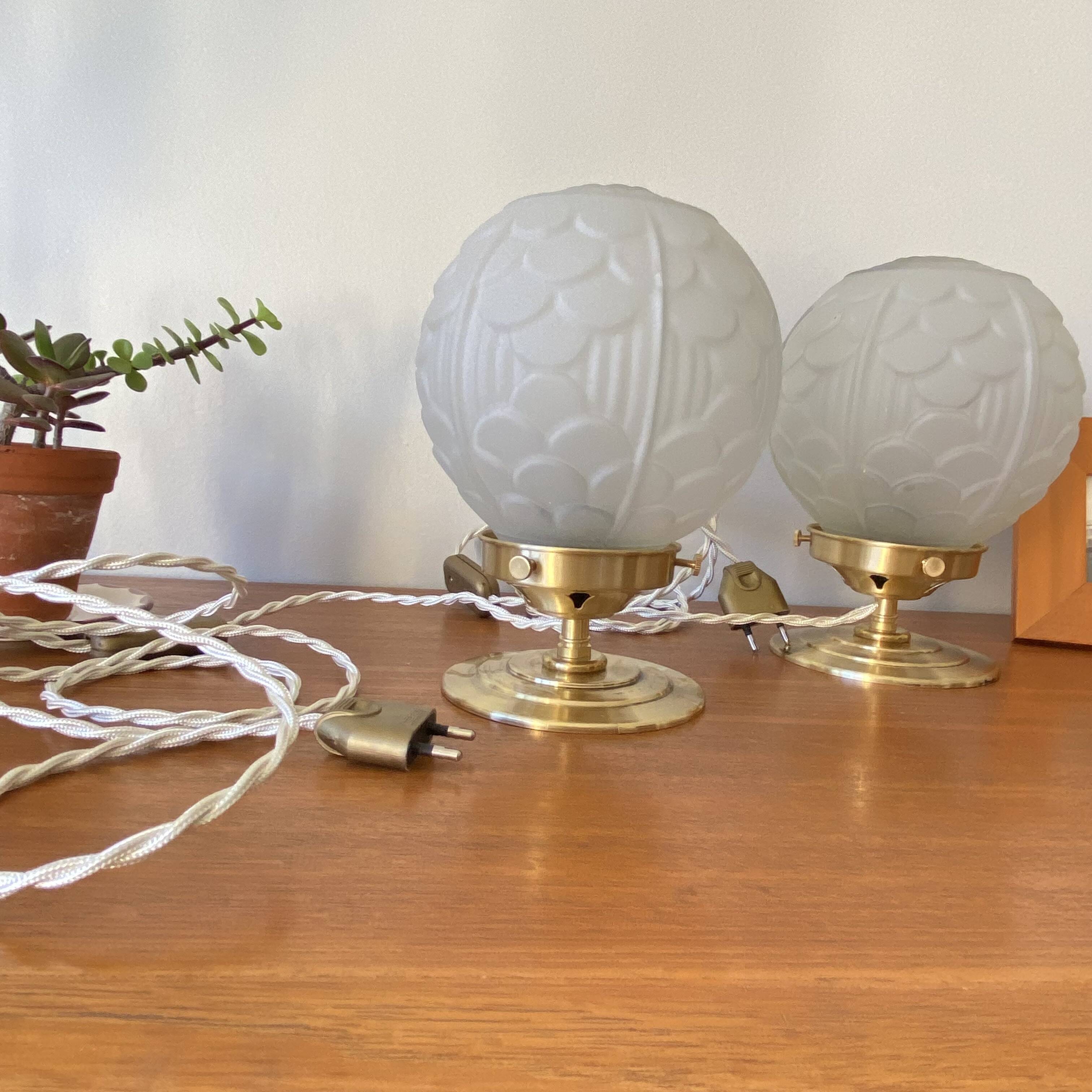 Pair of Art Deco glass globe table lamps with brass base.