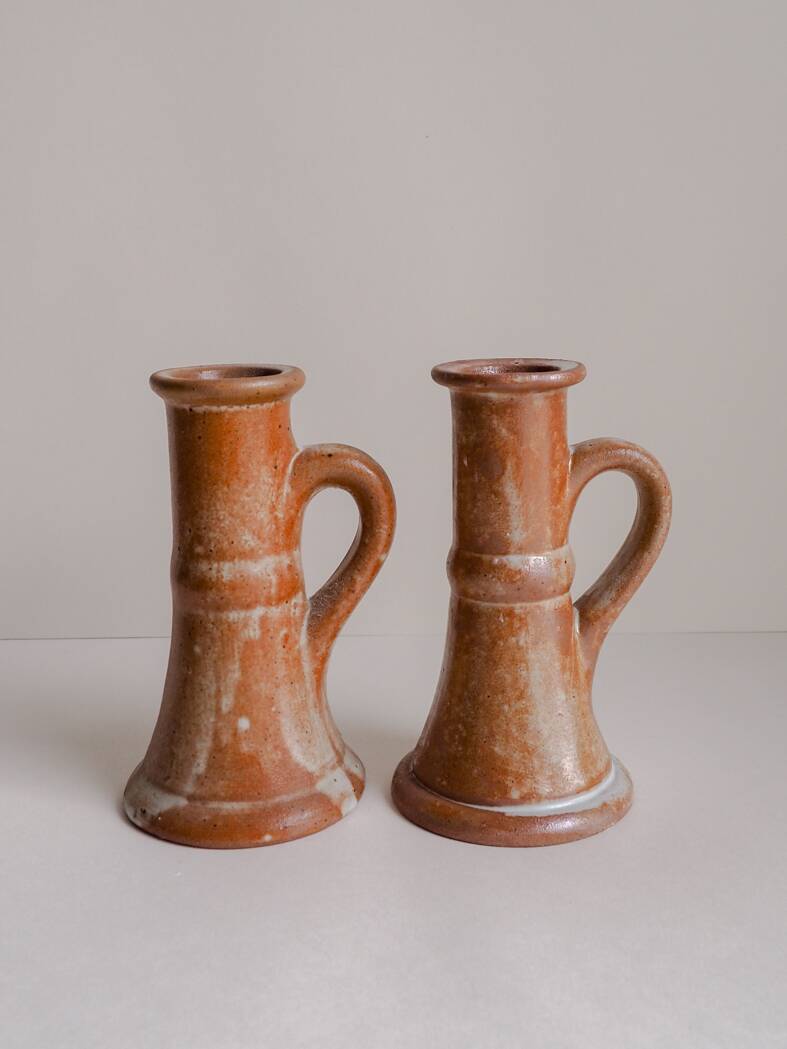 Set of two terracotta candle holders.