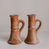 Set of two terracotta candle holders.